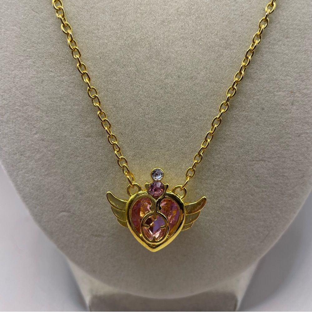 Pink heart with wings pendant on a gold tone chain. Sailor Moon inspired. Anime